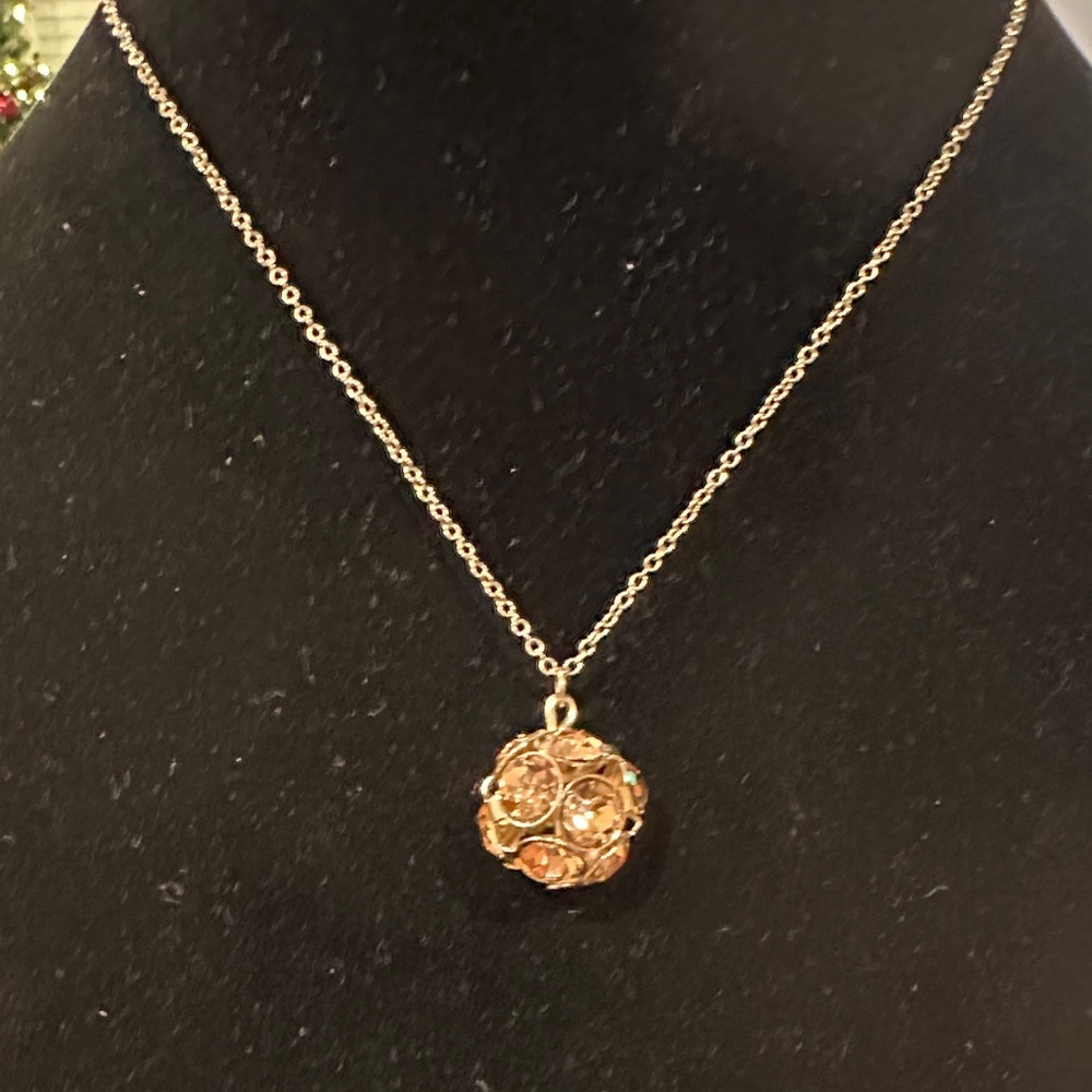 Antique brass and orange or amber colored crystal sphere pendant necklace.